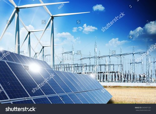 Solar panels and wind turbines in a power station with blue sky and clouds in the background.