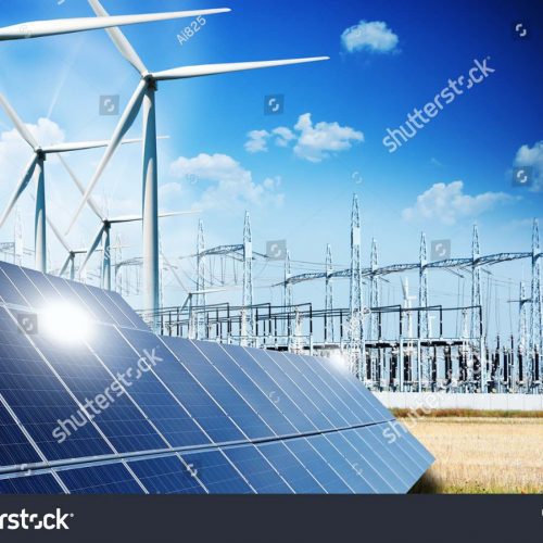 Solar panels and wind turbines in a power station with blue sky and clouds in the background.