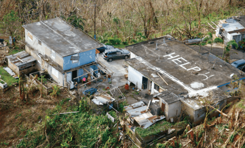 Aerial view of damaged buildings with the word 