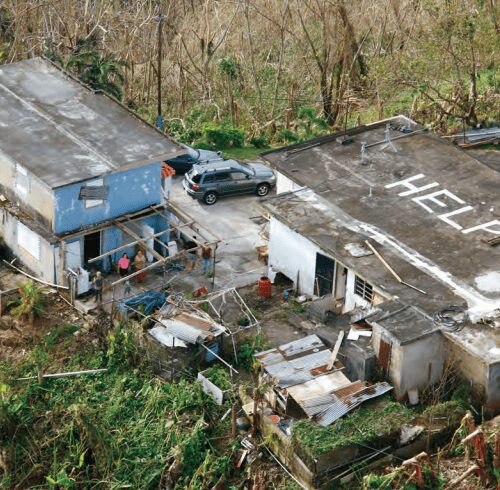 Aerial view of damaged buildings with the word 