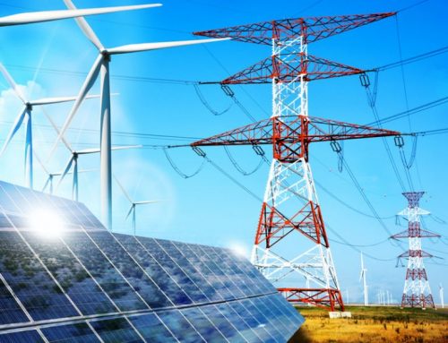 Solar panels and wind turbines near high-voltage power lines under a clear blue sky, highlighting renewable energy sources.