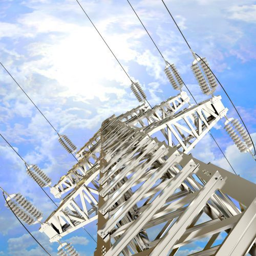 Low angle view of an electricity pylon against a cloudy sky, highlighting its metal framework and power cables.
