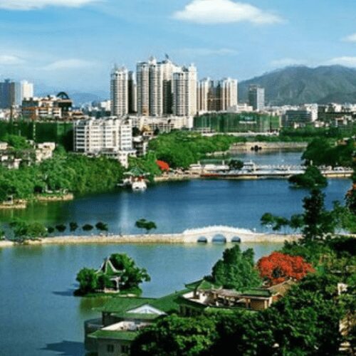 Cityscape with lake and bridge.
