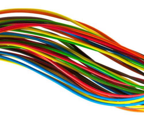 A bundle of colorful, multi-colored wires twisted together against a white background.