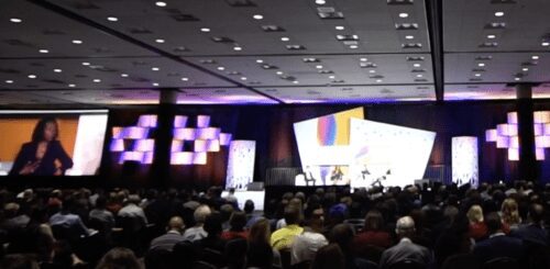 Large conference audience watching speaker.