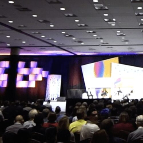 Large conference audience watching speaker.