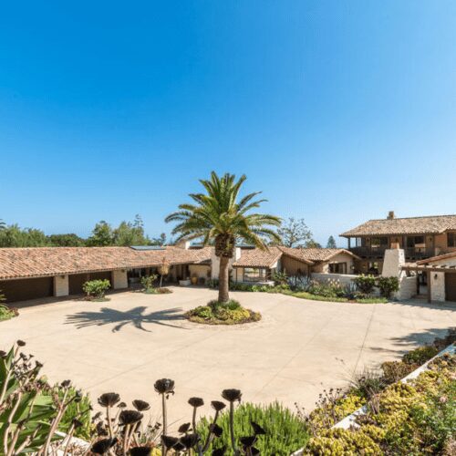 Wide driveway around palm in luxury ranch home