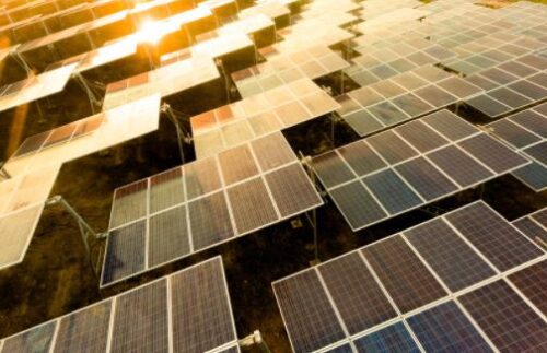 A large array of solar panels in the sun.