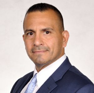 A man in a suit and tie standing up.