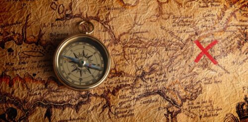 A compass on top of an old map.