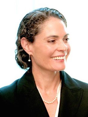 A woman with curly hair wearing a black jacket.