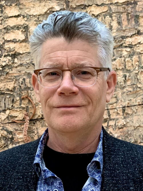 A man with glasses and a gray hair