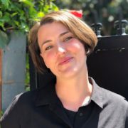 A woman with short hair wearing a black shirt.