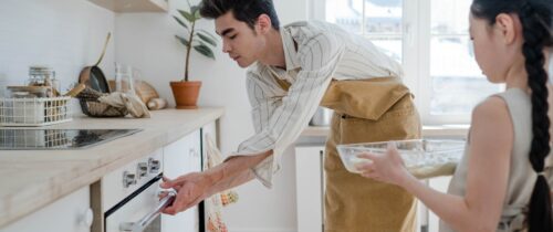 A man in an apron is holding something