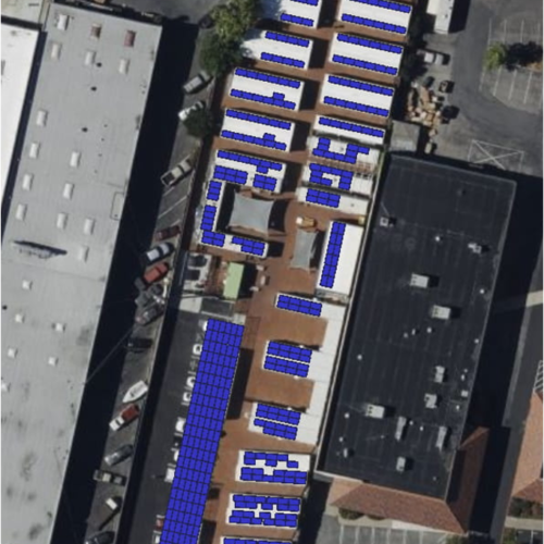 A view of an aerial photo of a building with solar panels.