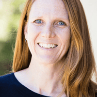 A woman with long red hair and blue eyes.