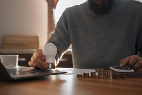 A man is holding an led light bulb