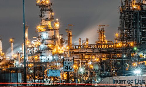 Night view of illuminated oil refinery.