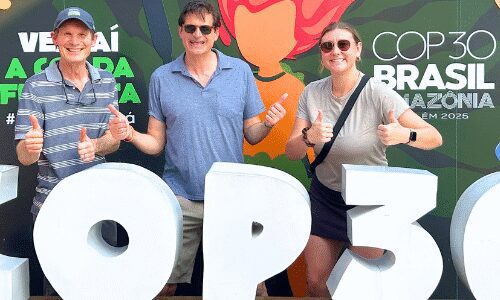 Three people posing at COP30 event.