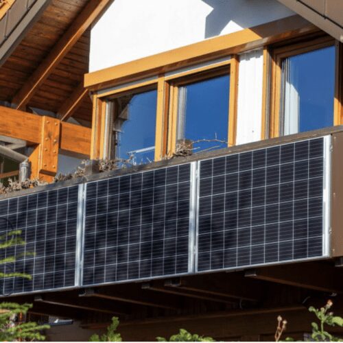 Balcony with solar panels on wooden house