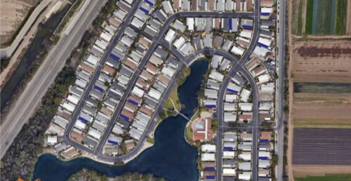 Aerial view of residential neighborhood and fields.